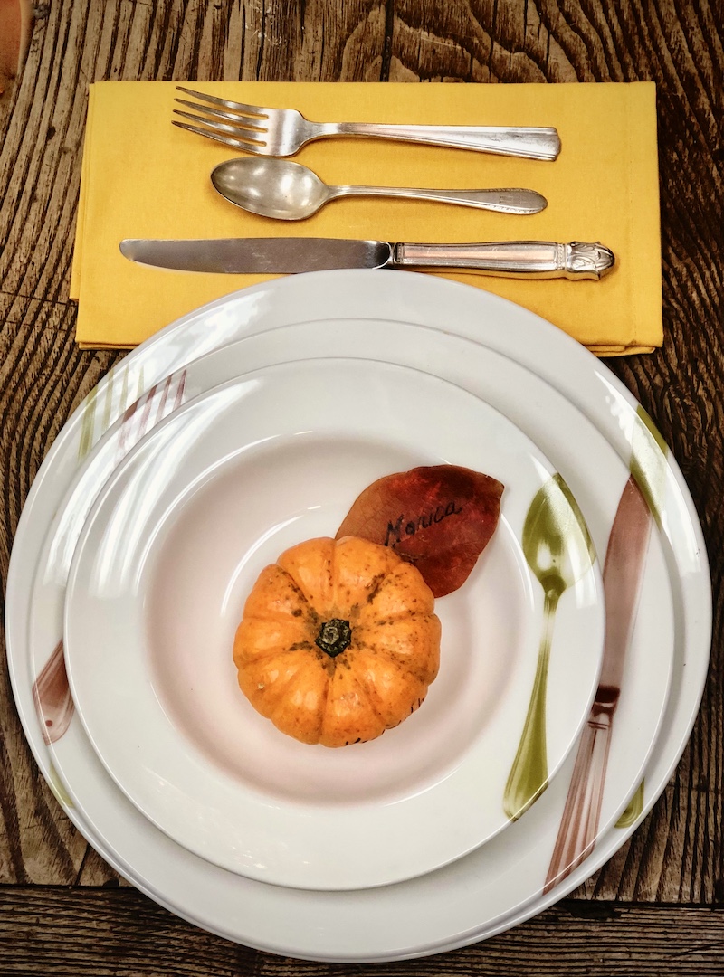 A contemporary pacesetting using an autumn leaf as a placecard.